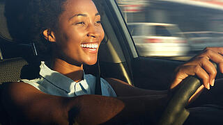 Young african american woman driving a car