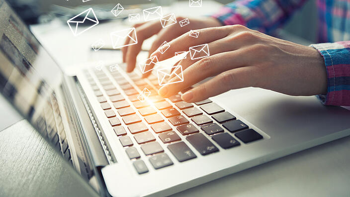  Business woman use tablet with email icons in work space. 