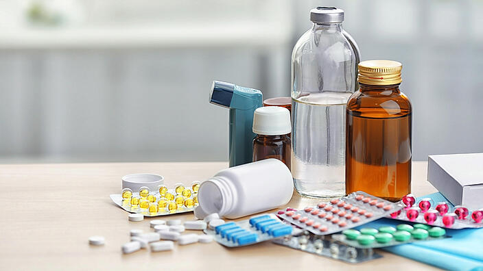  Different medicines and pills on wooden table