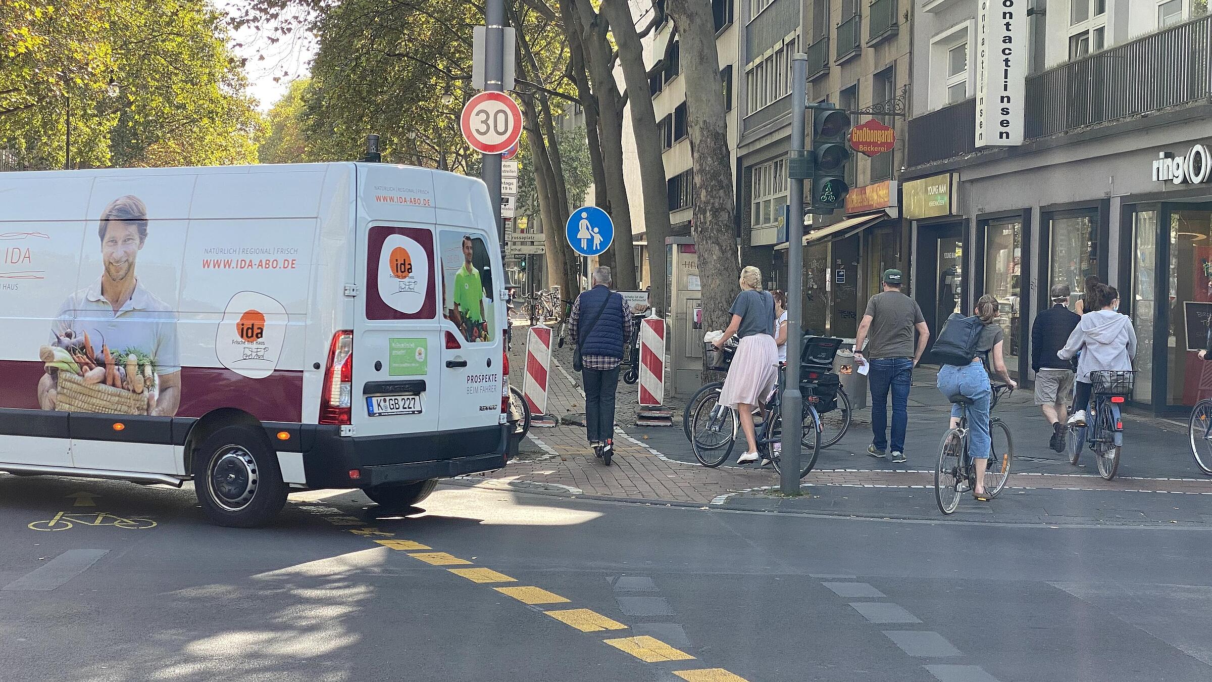 Anpassungsschwierigkeiten im Rad- und im Autoverkehr: Radfahrende nehmen das neue Angebot des breiten Radfahrstreifens auf der Fahrbahn trotz vielfältiger „Hinweise“ im Seitenraum nur zögerlich an